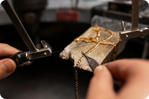 jeweler s hands making jewellery